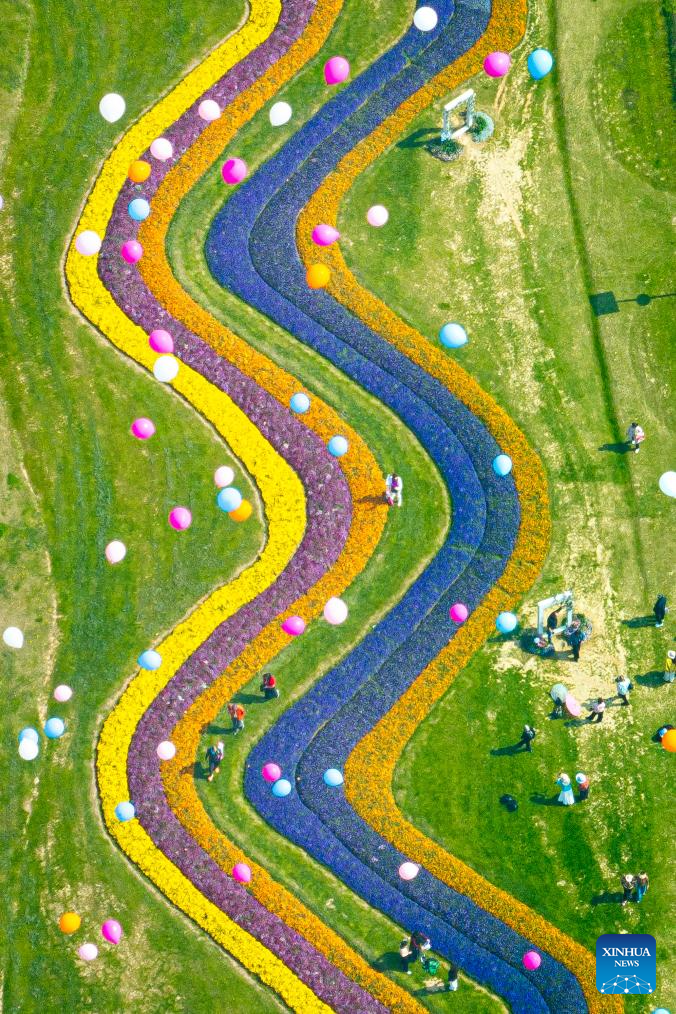 Foto dron yang diambil pada 14 Mac 2026 ini menunjukkan orang ramai sedang melihat bunga di sebuah taman di Wuhan, provinsi Hubei, tengah China. (Xinhua/Xiao Yijiu)