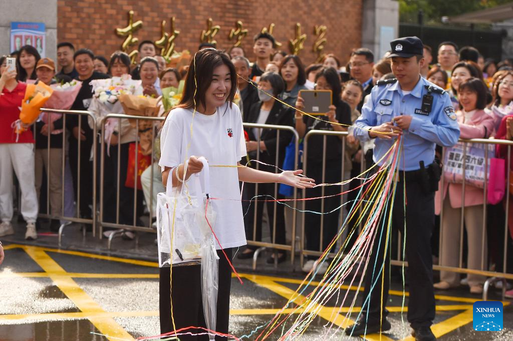 Seorang pelajar disambut dengan riben berwarna selepas peperiksaan kemasukan universiti awam di Changchun, provinsi Jilin, timur laut China, 9 Jun 2026. (Foto oleh Zhang Nan/Xinhua)