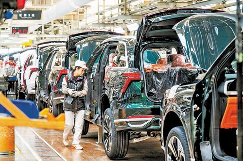 Pekerja memasang kenderaan tenaga baharu di barisan pengeluaran di suatu bengkel Hebei. (Hebnews.cn/Zhao Jie)