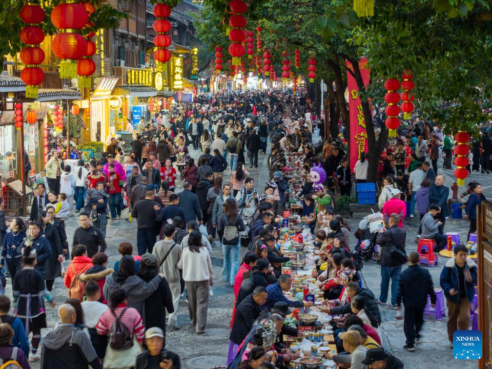 Jamuan meja panjang diadakan sempena festival Tahun Baharu Dong di kampung Dong Zhaoxing, kaunti Liping, daerah autonomi Miao dan Dong Xiangdongnan, provinsi Guizhou, barat daya China, 20 Disember 2025. (Foto oleh Long Jianrui/Xinhua)